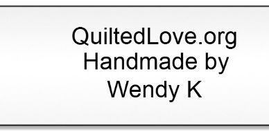 Label showing QuiltedLove.org, handmade by Wendy K.