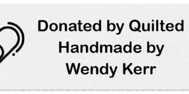 Label stating quilt donation by Wendy Kerr.