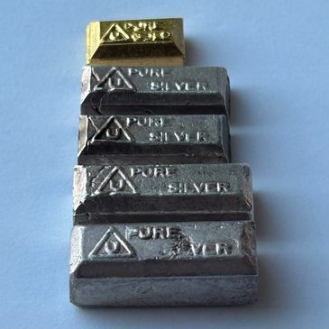 Stacked gold and silver bars labeled as pure metals.