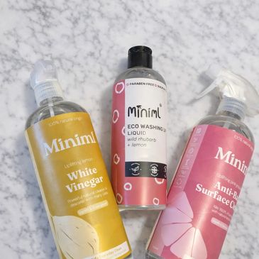 Three Minimi cleaning products on a marble surface.