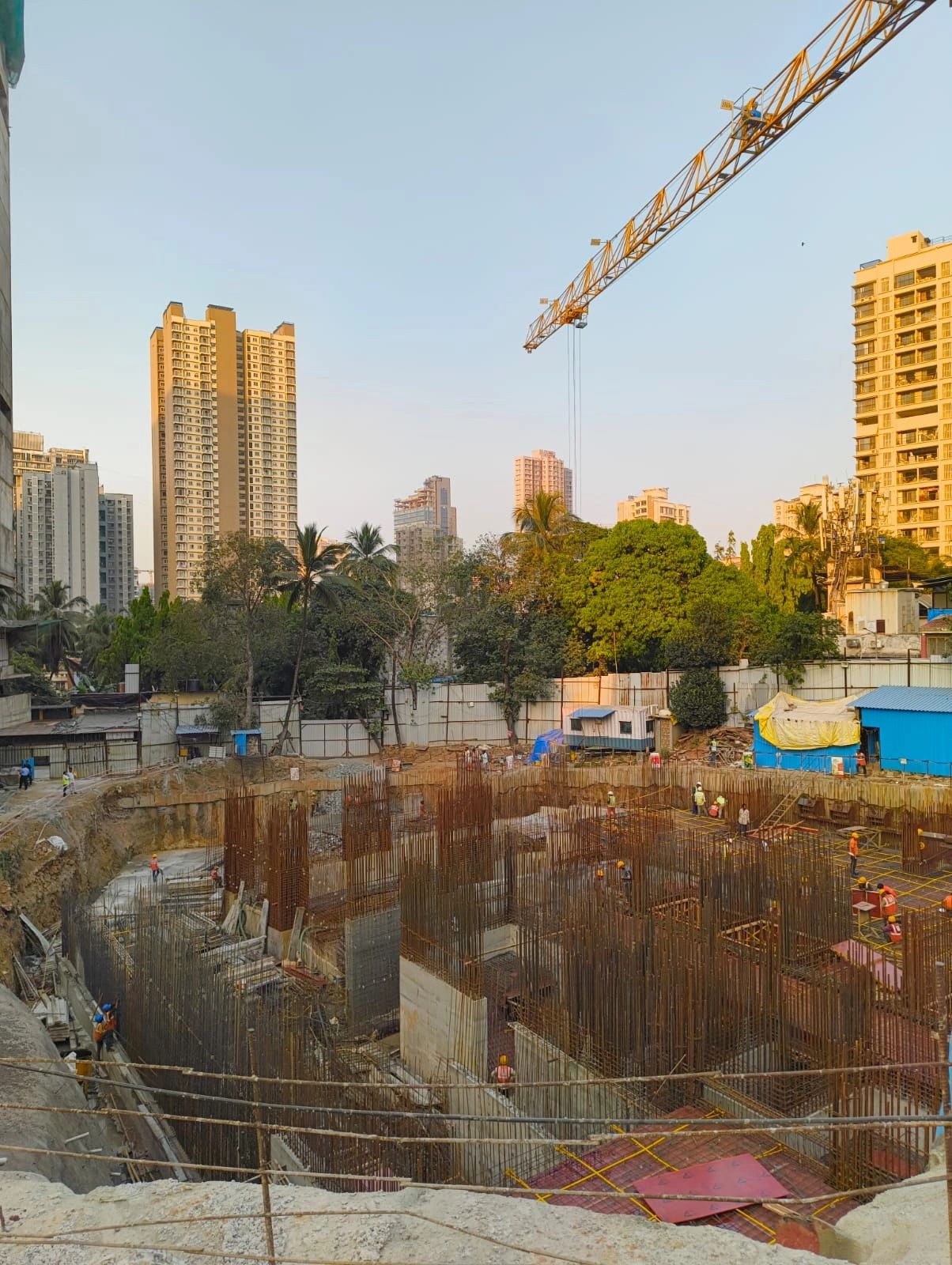 High-rise building under construction with scaffolding and safety nets.