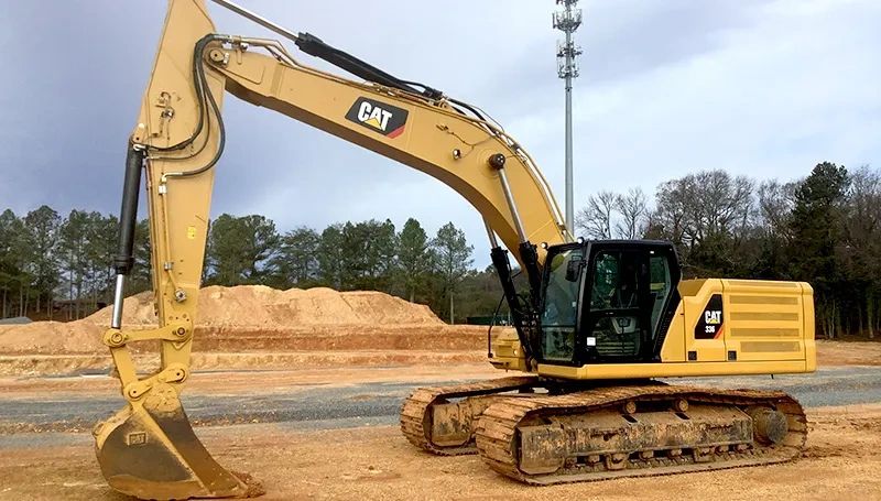 A yellow CAT excavator on a construction site.