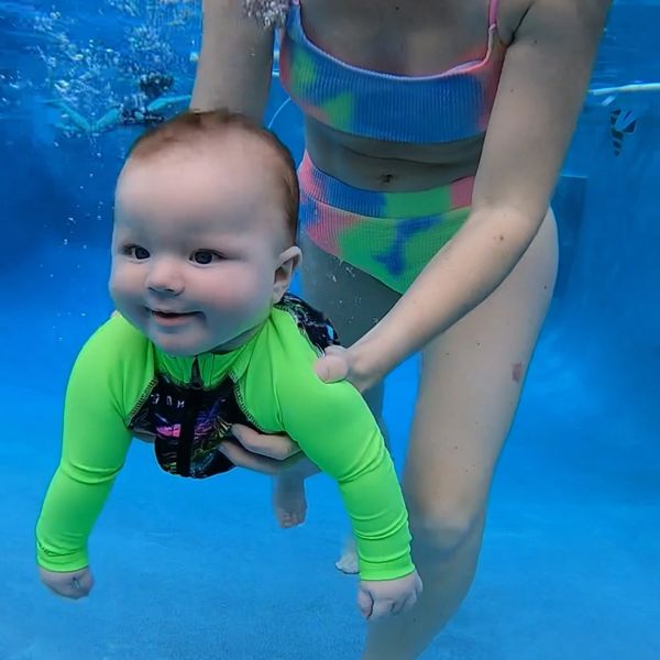 A baby swimming in the pool.