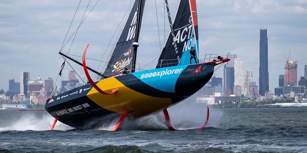 Team Malizia with Cole on the bow in from of the NYC city front.