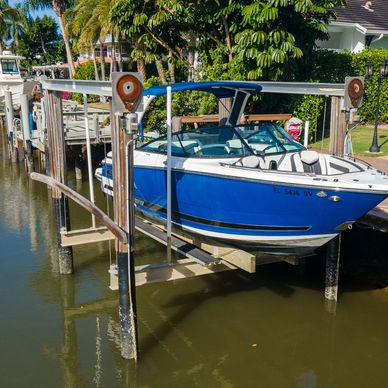 Blue and white boat docked above water.