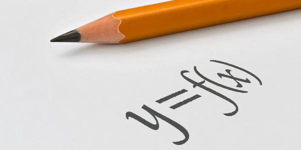 A Yellow Pencil lying on a White Page with a function written on it.