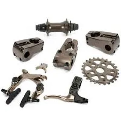 Various metallic bicycle parts including brake components and sprocket.