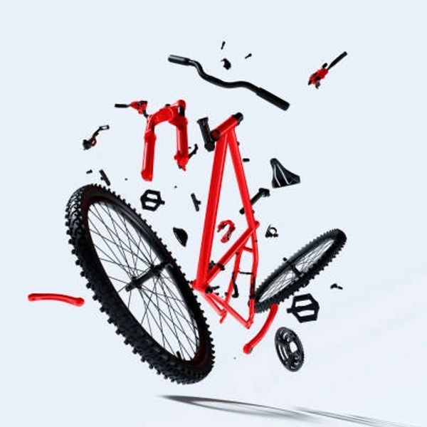 Disassembled red and black bicycle parts floating on a light background.