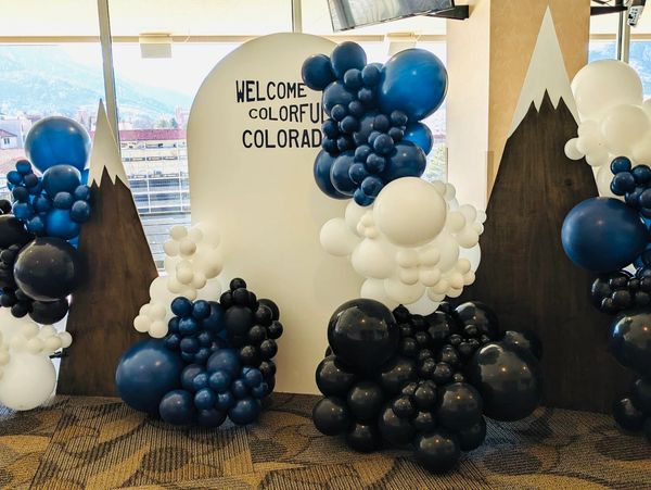 custom onsite balloon installation including wooden chiara arch, mountain arch, and organic balloons