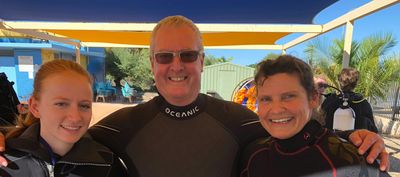 smiling scuba instructors with Peter