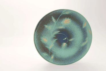 Decorative ceramic plate with floral design.