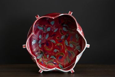 Decorative red bowl with floral patterns.