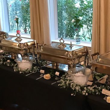 Wedding Buffet table with black linens, white flowers, and silver decorations