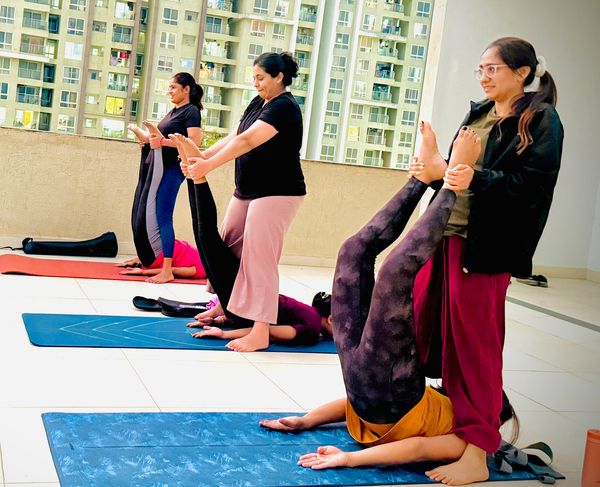 A special session, assisting each other in an inversion pose for deeper stretching and balance."
