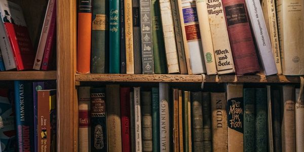 Bookshelves filled with old, worn books in various colors and sizes.