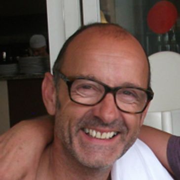 Smiling man wearing glasses.