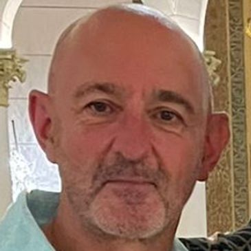 Portrait of a middle-aged man with a neutral expression.