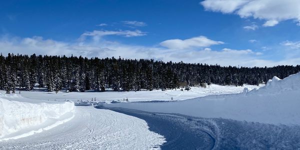 Snow covered road with tall snowbanks