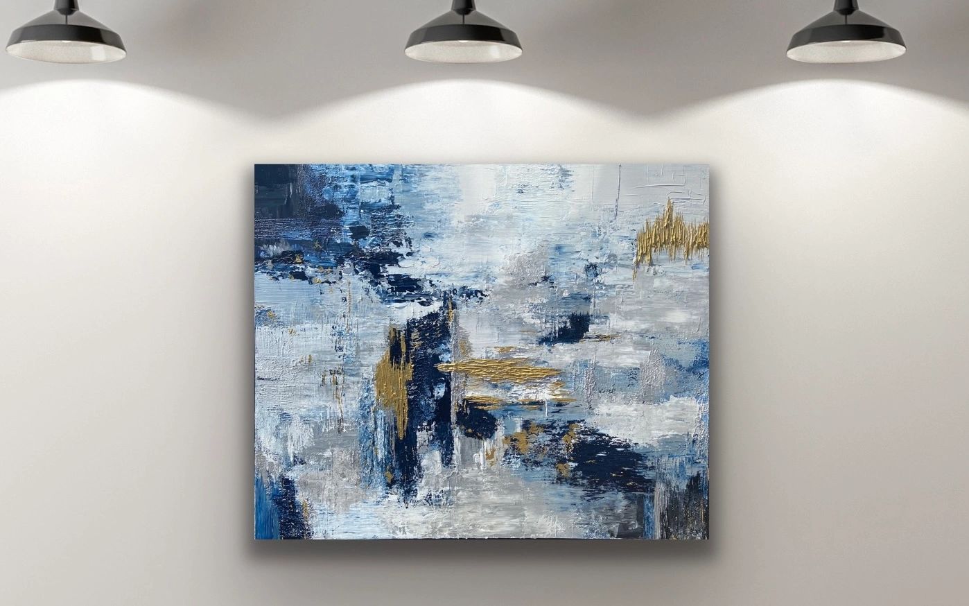 Navy, gold, white and grey abstract art hanging on wall