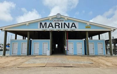 Causeway Marina building with blue doors under a blue sky.
