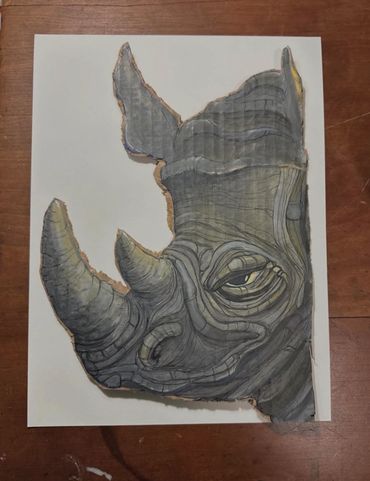 Detailed drawing of a rhino head on a piece of paper.