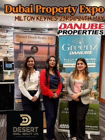 Three women at Dubai Property Expo booth.