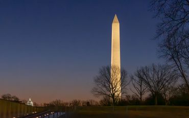 Washington Monument illuminated at dusk.