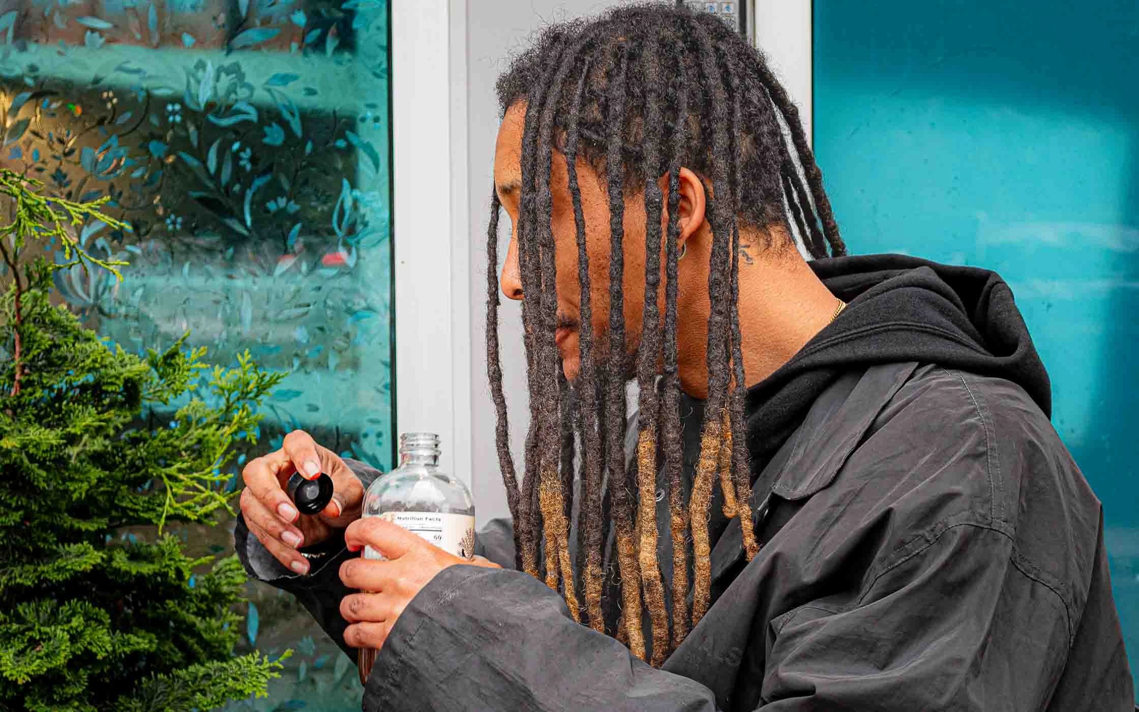 Person opening a bottle outdoors.