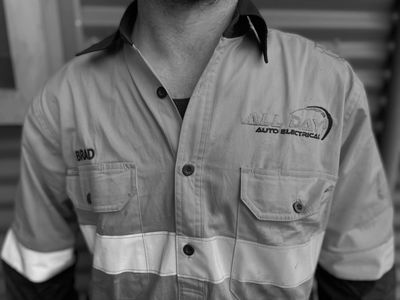 Man wearing a work shirt with name and company logo.