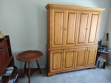 55" Maple TV Bureau with storage cabinets beneath.  Top doors fold to the side and then slide into t