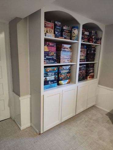 Bookshelf with cabinets for game storage. Built to match existing woodwork. Soft close hinges