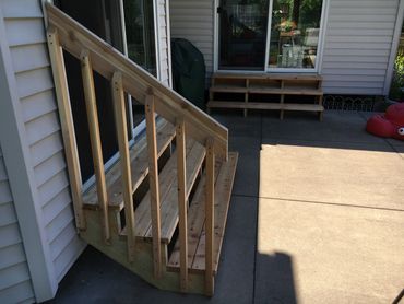 Rebuilt two sets of stairs utilizing green treated stair stringers and cedar steps and railing. 