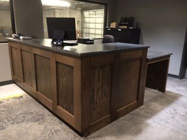 Oak front office desk with shelves. ADA accessible desk. Laminate countertop. Locking cash drawer