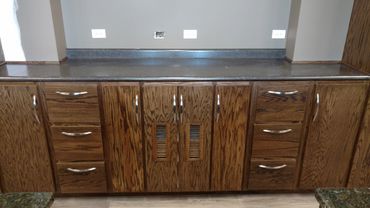 Oak front office cabinets and shelves. ADA accessible desk. Laminate countertop. Locking cash drawer