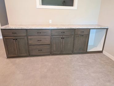 Lower-level cabinets. Oak doors and drawer faces, stained to match existing woodwork. Soft close doo