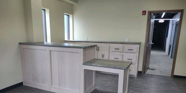 Small business front entry way customer counter with ADA accessible end, lock box, file folder drawe