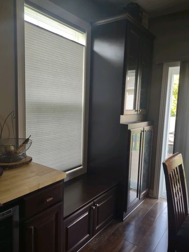 Cherry built in cabinets to match existing kitchen cabinets. Butcher block top with window seat. 