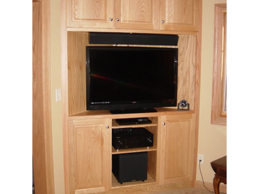 Oak corner entertainment cabinet. Designed and built to match existing woodwork in house. 