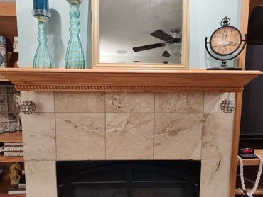 Classic oak gas fireplace mantel with decorative rope trim accent.   