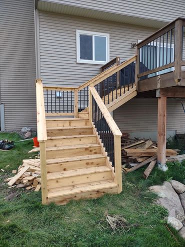 Added cedar staircase to existing deck while matching current deck railing design. 