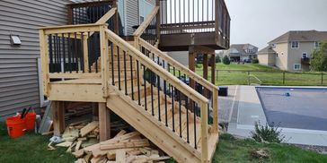 Added a cedar staircase to an existing deck to gain easier access to newly installed swimming pool. 