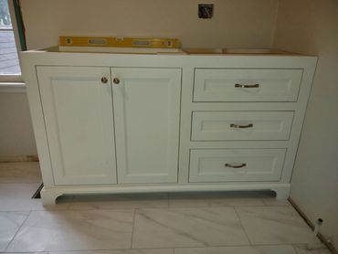 Bathroom vanity with flush mounted doors and drawers. Soft close hardware. 