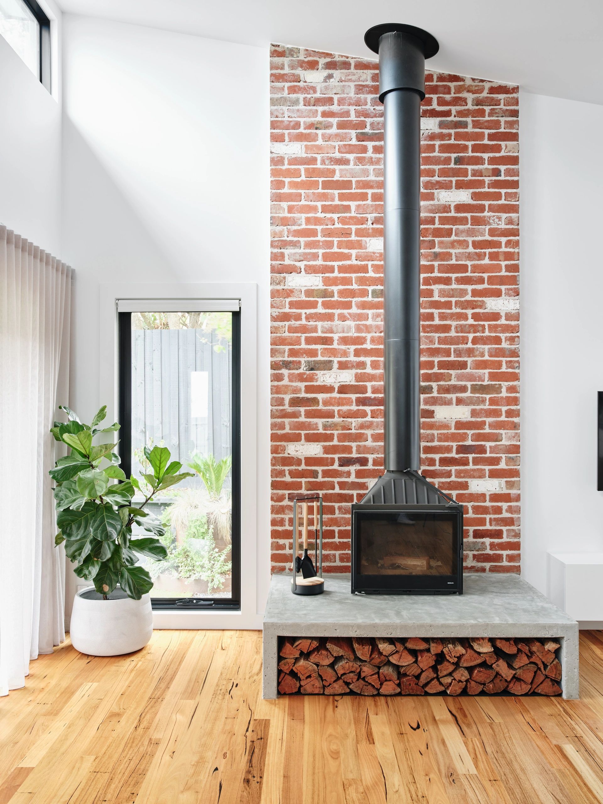 High ceilings with fireplace and custom concrete plinthe
