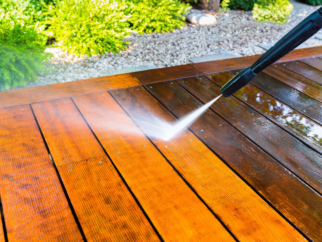 Power washing a wooden deck.