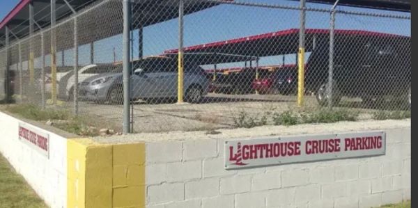 Lighthouse Cruise parking area behind a chain-link fence.