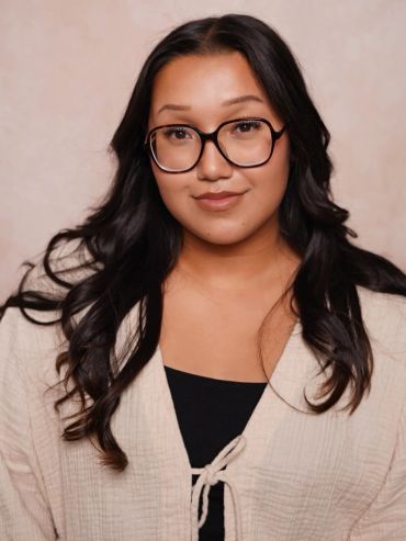 Young woman with glasses and long dark hair.