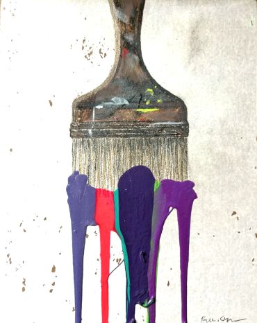 Paintbrush with dripping colorful paint on a white surface.