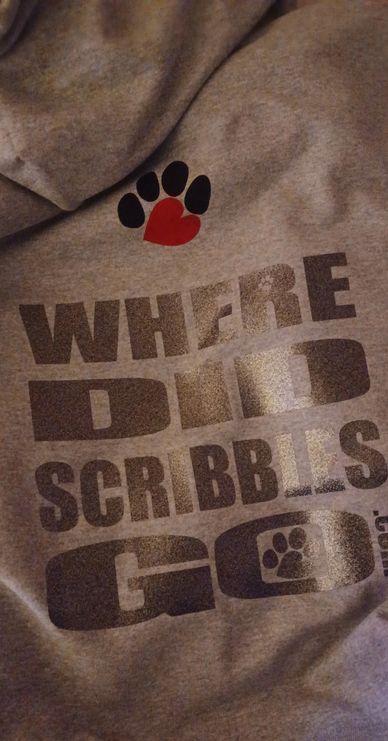 Grey fabric with text and paw print design including a heart shape.