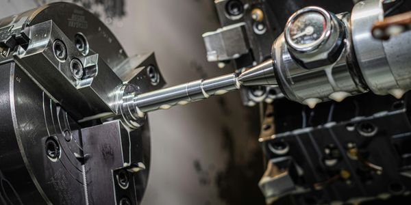 Close-up of a metal precision machining process on a lathe.