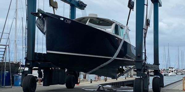 Boat lifted by Tammy Lifter at a marina.